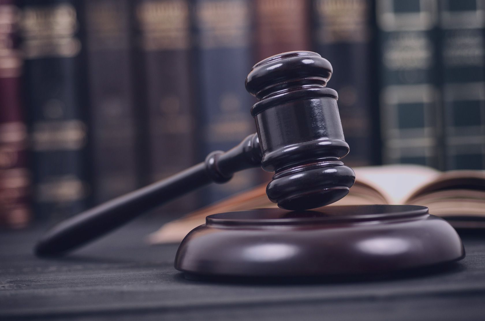 bigstock-Law-And-Justice–Legality-Con-338716546 Judge Gavel and law book on a black wooden background