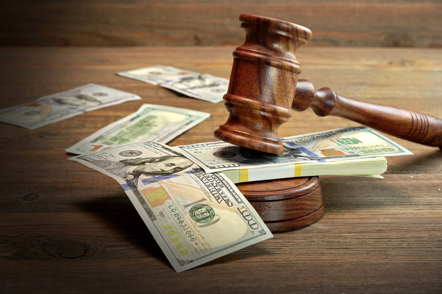 a gavel next to a pile of money