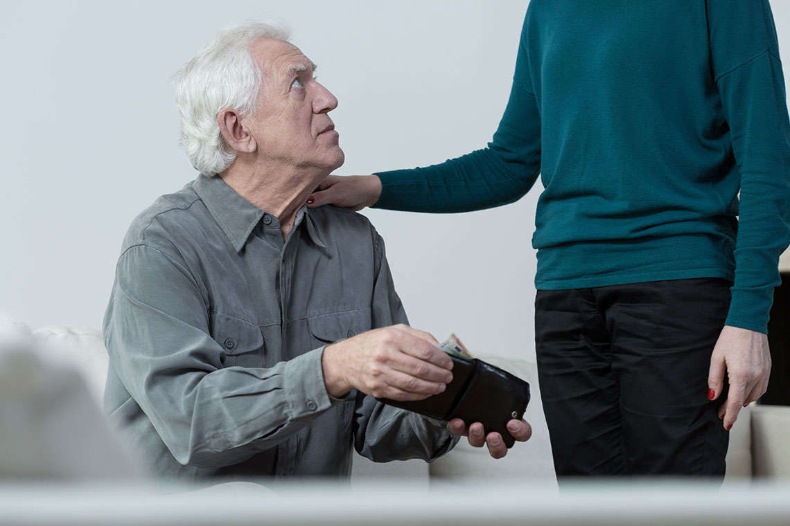 young woman taking money from older man