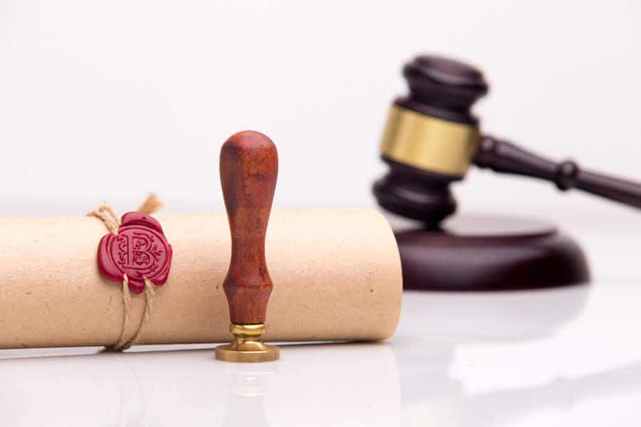 gavel next to rolled and sealed document